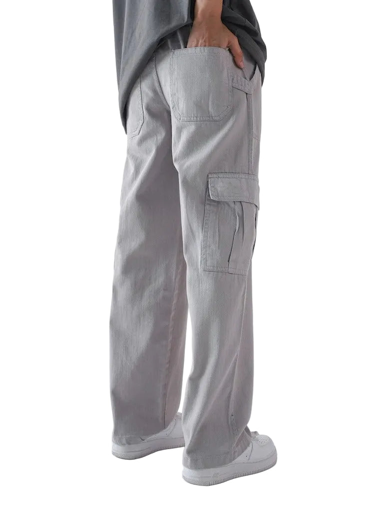 Person wearing gray cargo pants on a white background