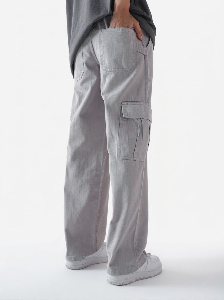 Person wearing gray cargo pants on a white background