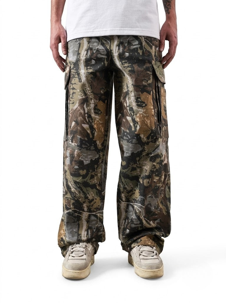 Camouflage cargo pants worn by a person on a white background