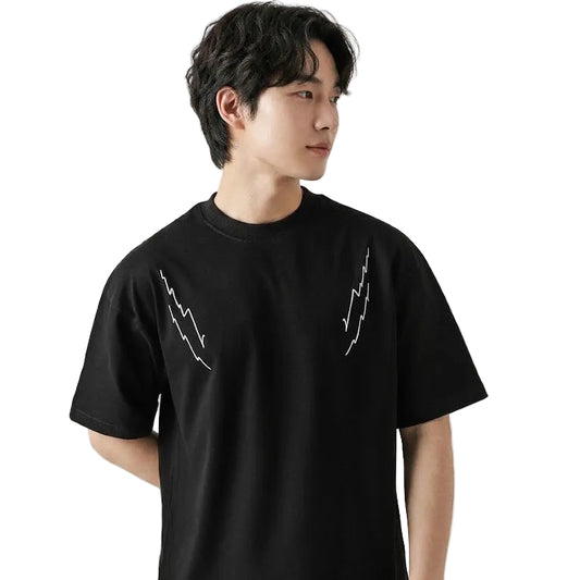Person wearing a black t-shirt with white graphics on a plain background