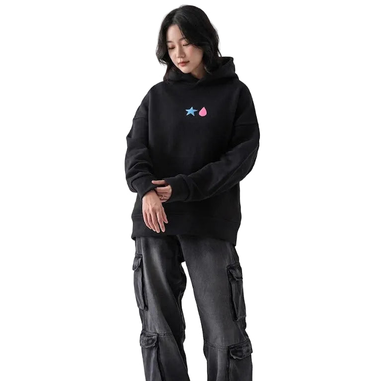 Person wearing a black hoodie with a colorful logo and dark cargo pants on a white background