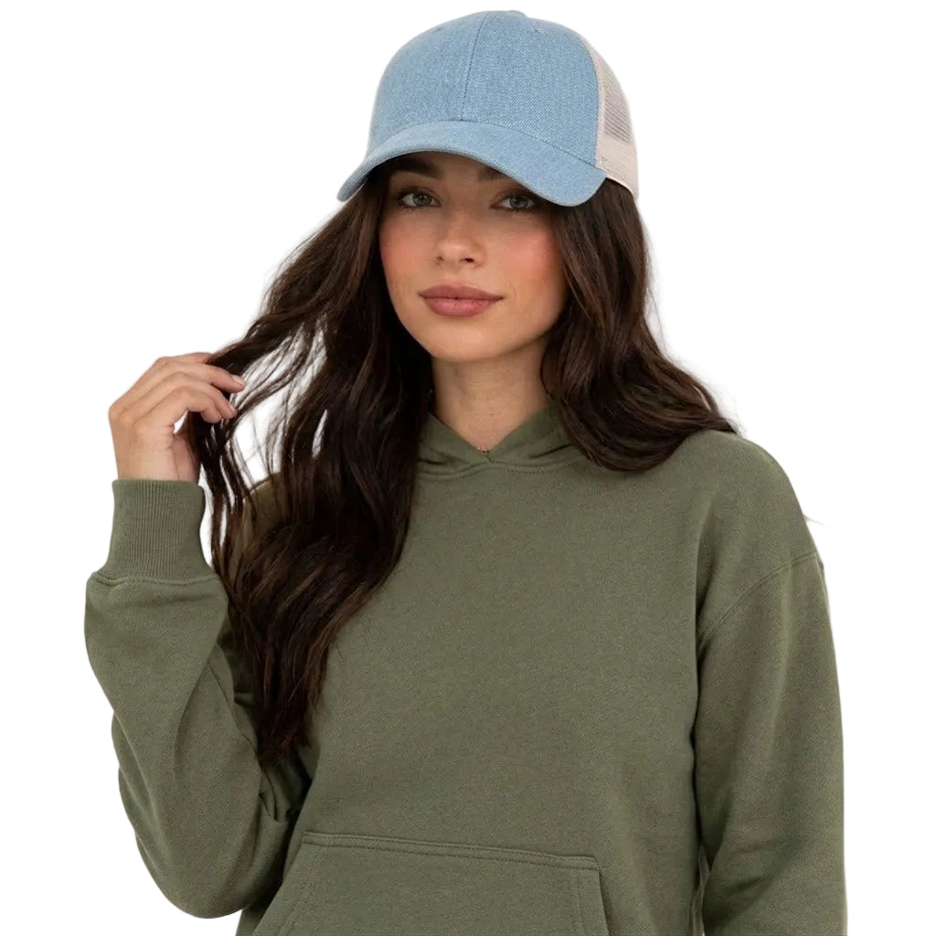 Woman wearing a green hoodie and blue cap on a white background