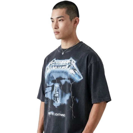 Person wearing a black t-shirt with graphic design on a plain background