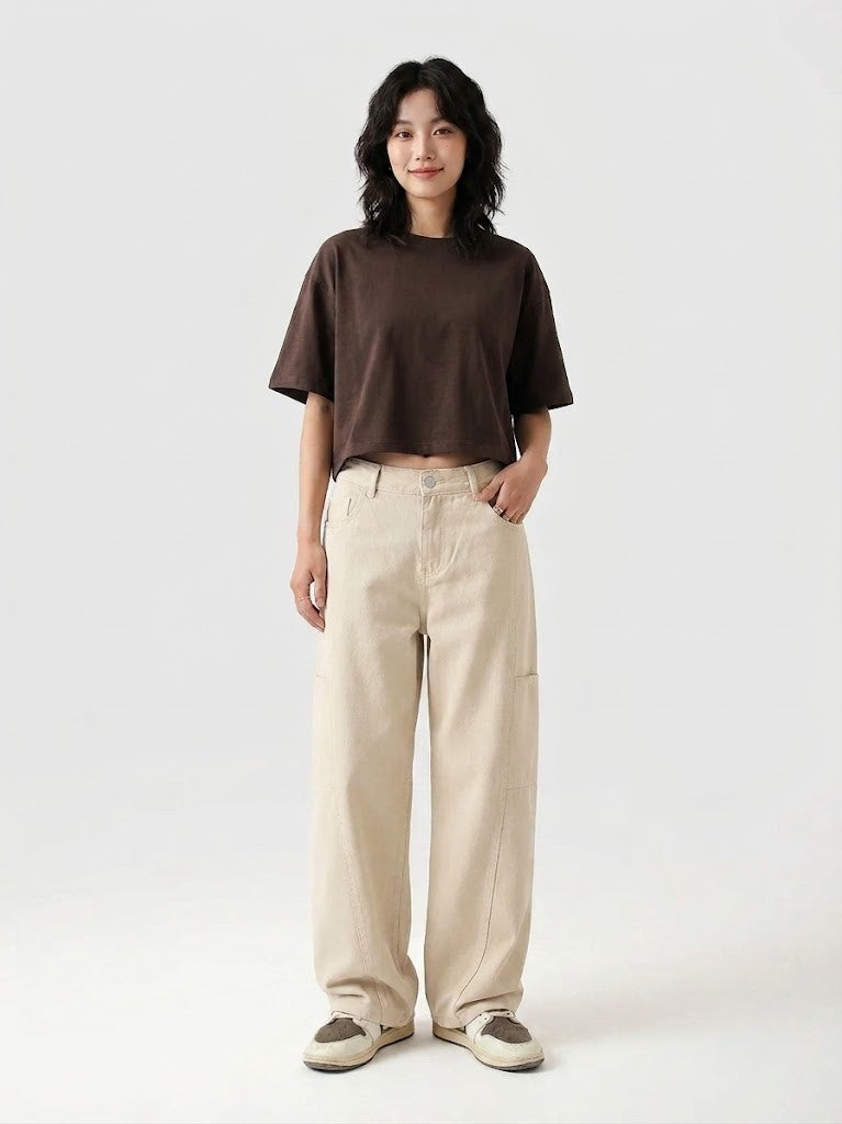 Person wearing a brown t-shirt and beige pants on a white background