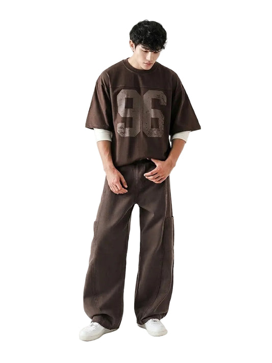 Person wearing a brown oversized t-shirt with '96' printed on it and matching pants on a white background