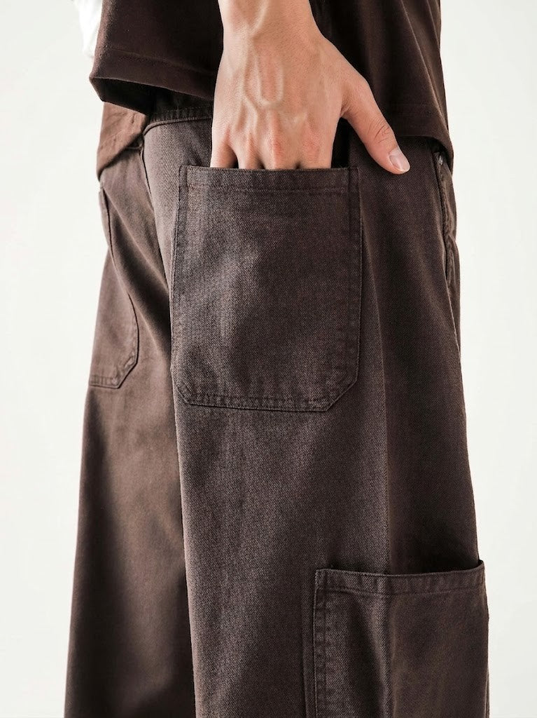 Brown pants with a pocket on a plain background